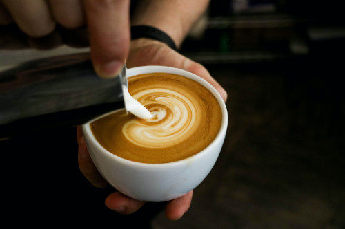 Cappuccino being poured into a cup