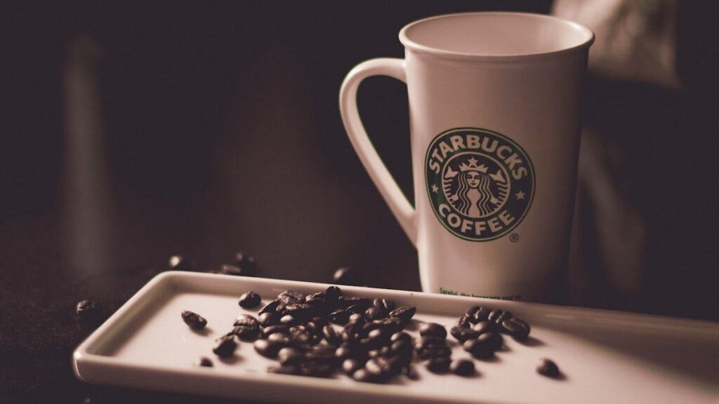 Starbucks Coffee Mug and Beans. Photo by Hans Vivek.
