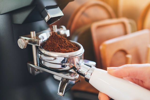 Automatic coffee grinder in action. Photo by Nguyen Tong Hai Van.