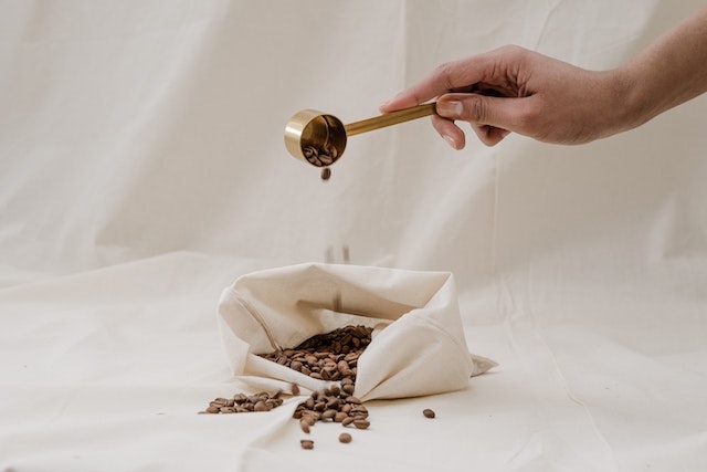 Measuring fresh coffee beans.