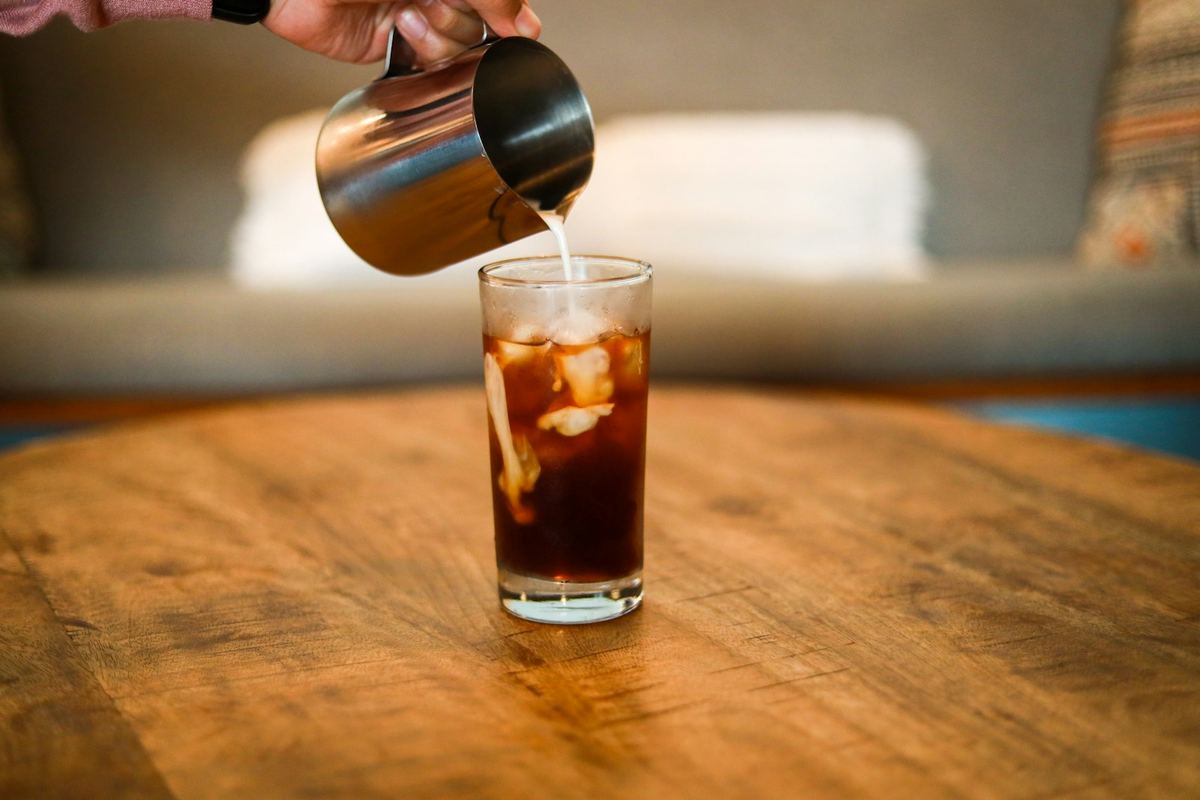 Cold brew coffee being poured into a glass. Photo by Kirby Fortenberry on Unsplash.