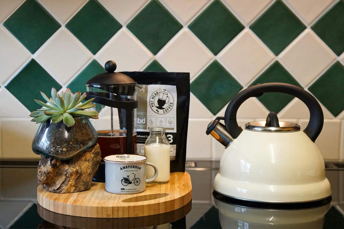 Brewing coffee in a cafetière / French press at home. Photo by Pot Head Coffee on Unsplash.