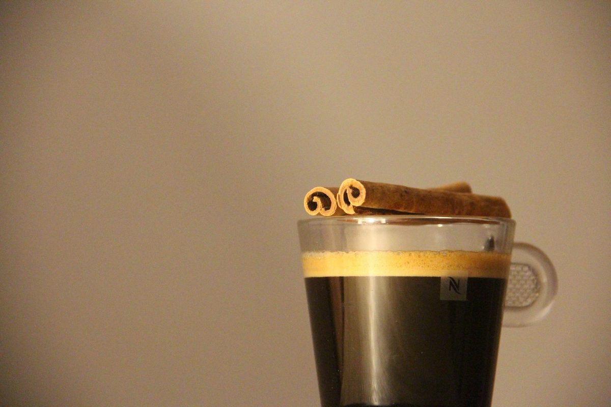 Nespresso coffee with cinnamon sticks. Photo by Denise Jans on Unsplash.