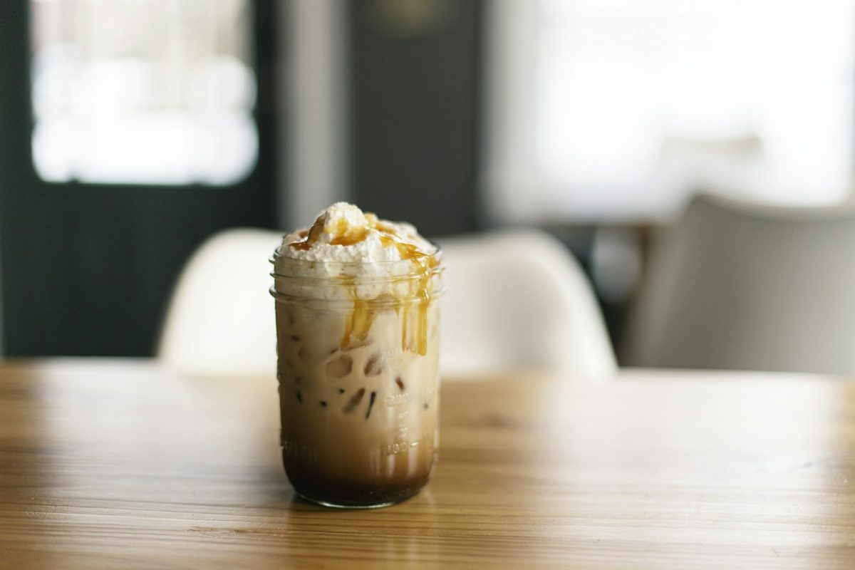 An iced caramel macchiato with espresso poured over milk and ice