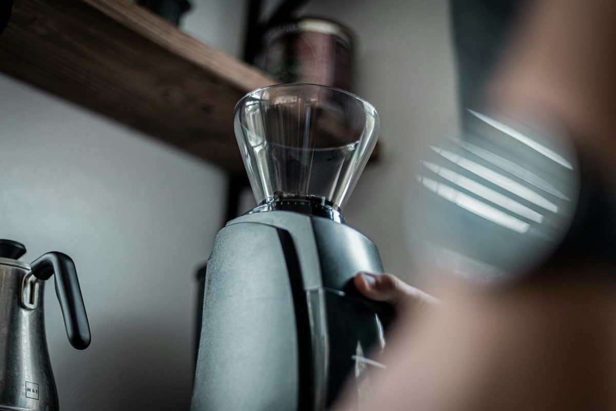 Using a handheld frother to foam milk in a cup at home