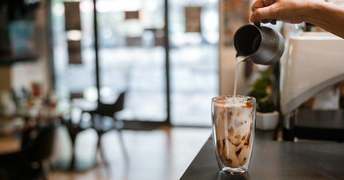 Espresso poured over iced milk layers beautifully