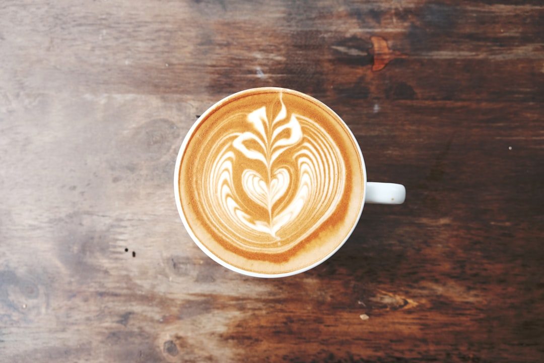 A latte in a white ceramic mug