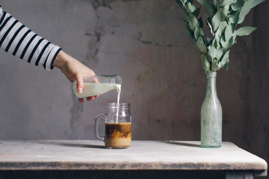 Pouring sweet cream over iced cold brew