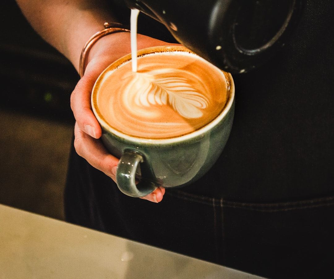 Steamed milk being poured into a latte